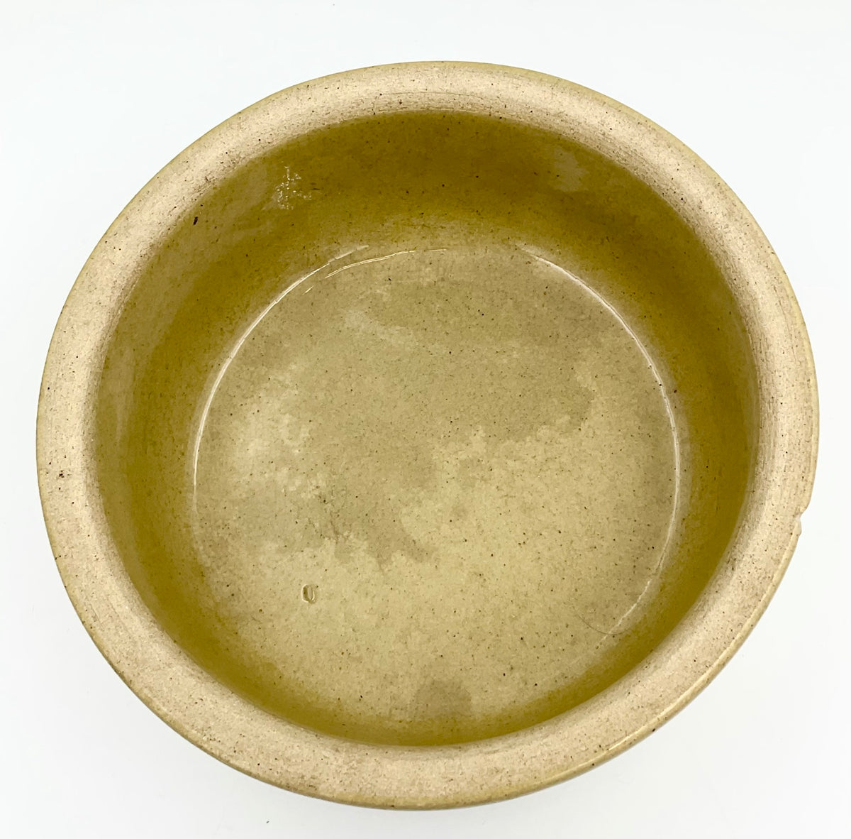 Interior of tan glazed stoneware dog dish