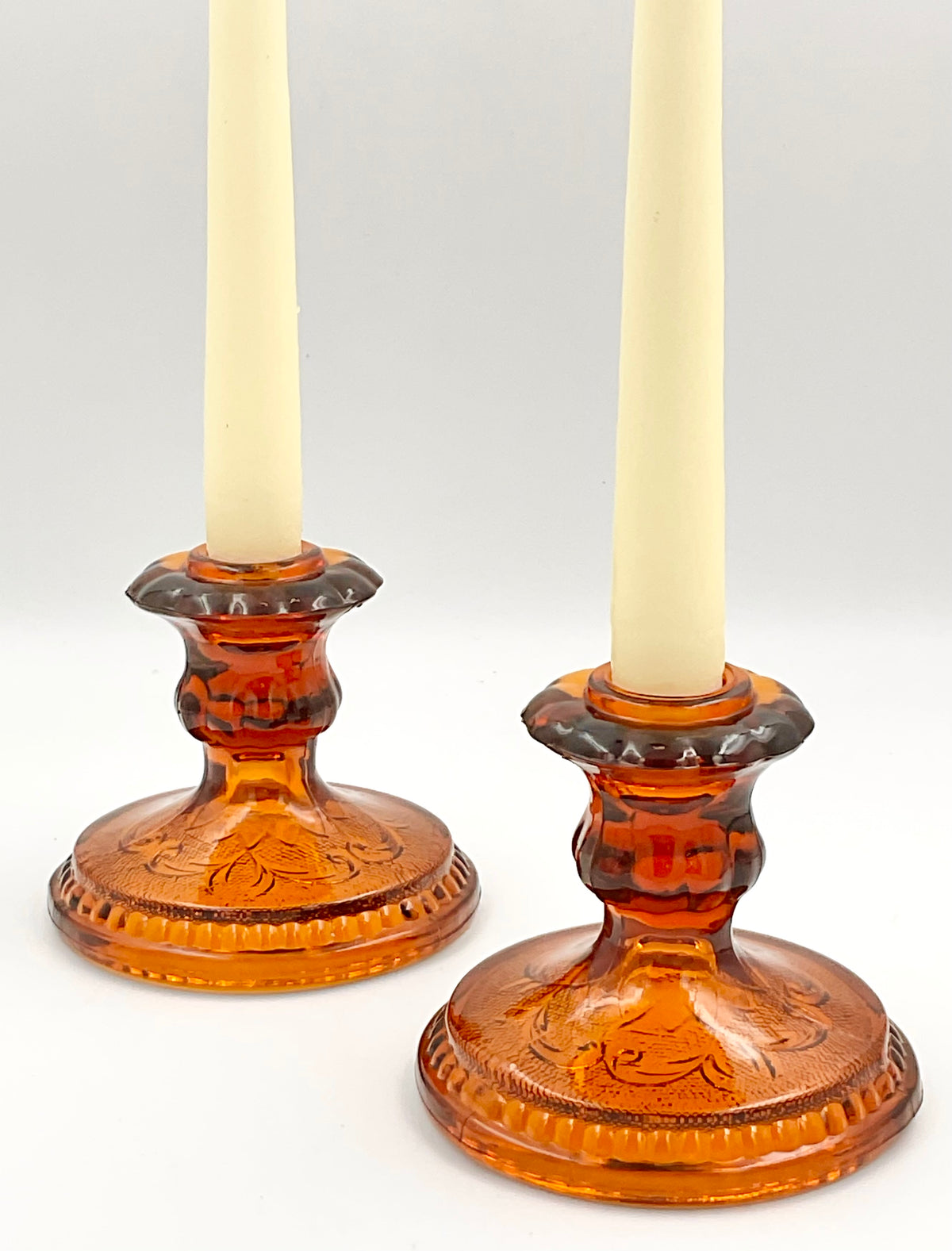 Indiana Glass amber Sandwich candle holders styled with taper candles