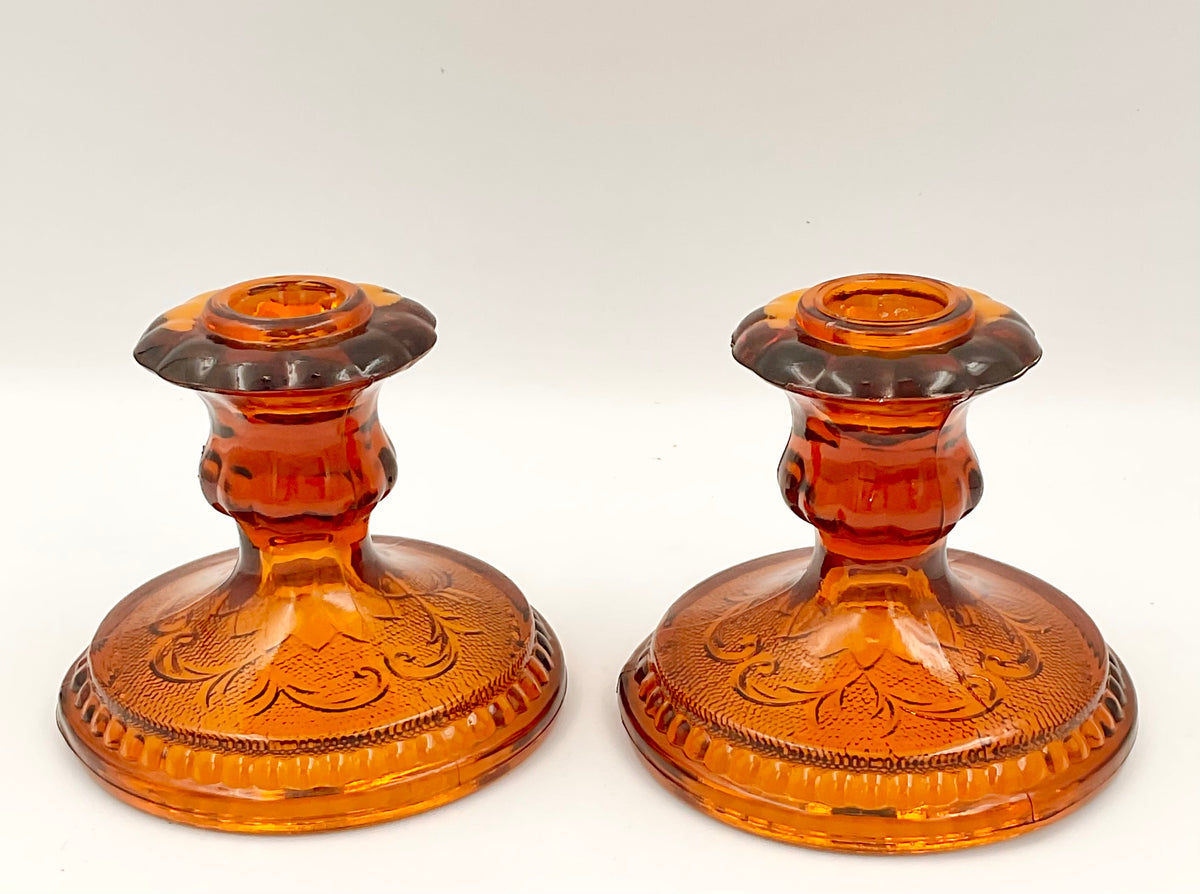 Front view of Indiana Glass amber Sandwich candle holder pair