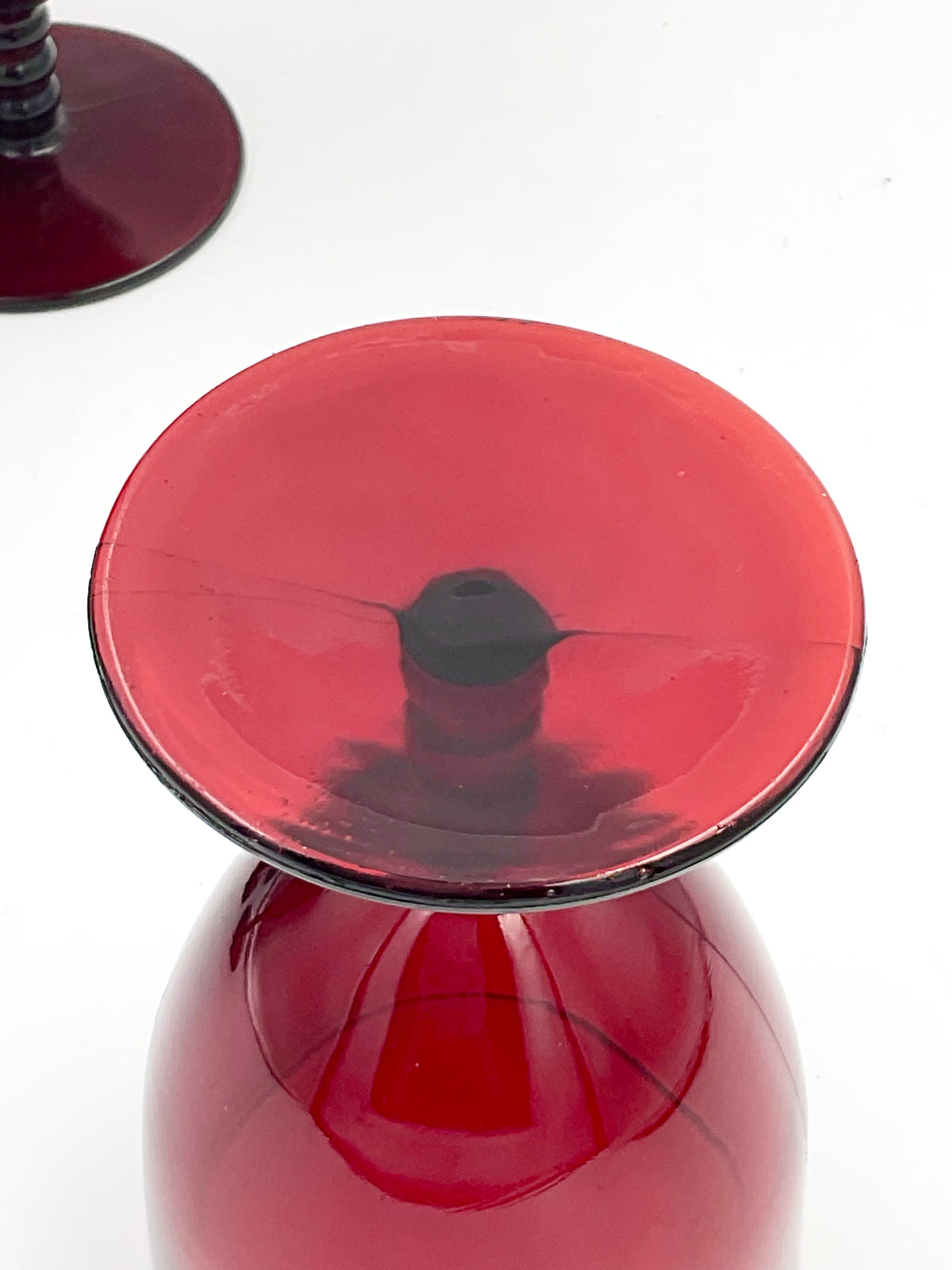 Underside of ruby red goblet base