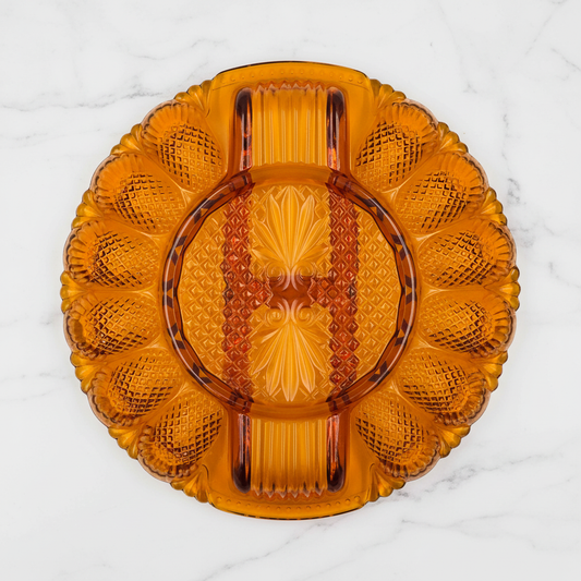 L.E. Smith Amber Moon and Stars Deviled Egg Plate overhead view on white marble